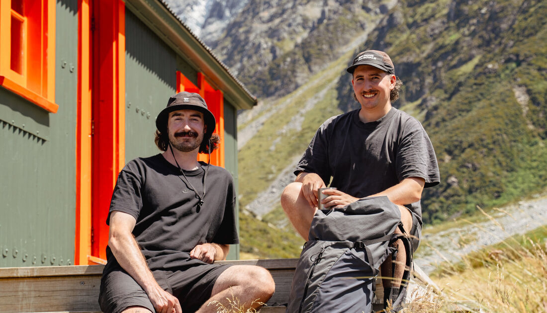 Easys founders Conor and Brayden sitting down after a hike outside a back country hut in New Zealand.
